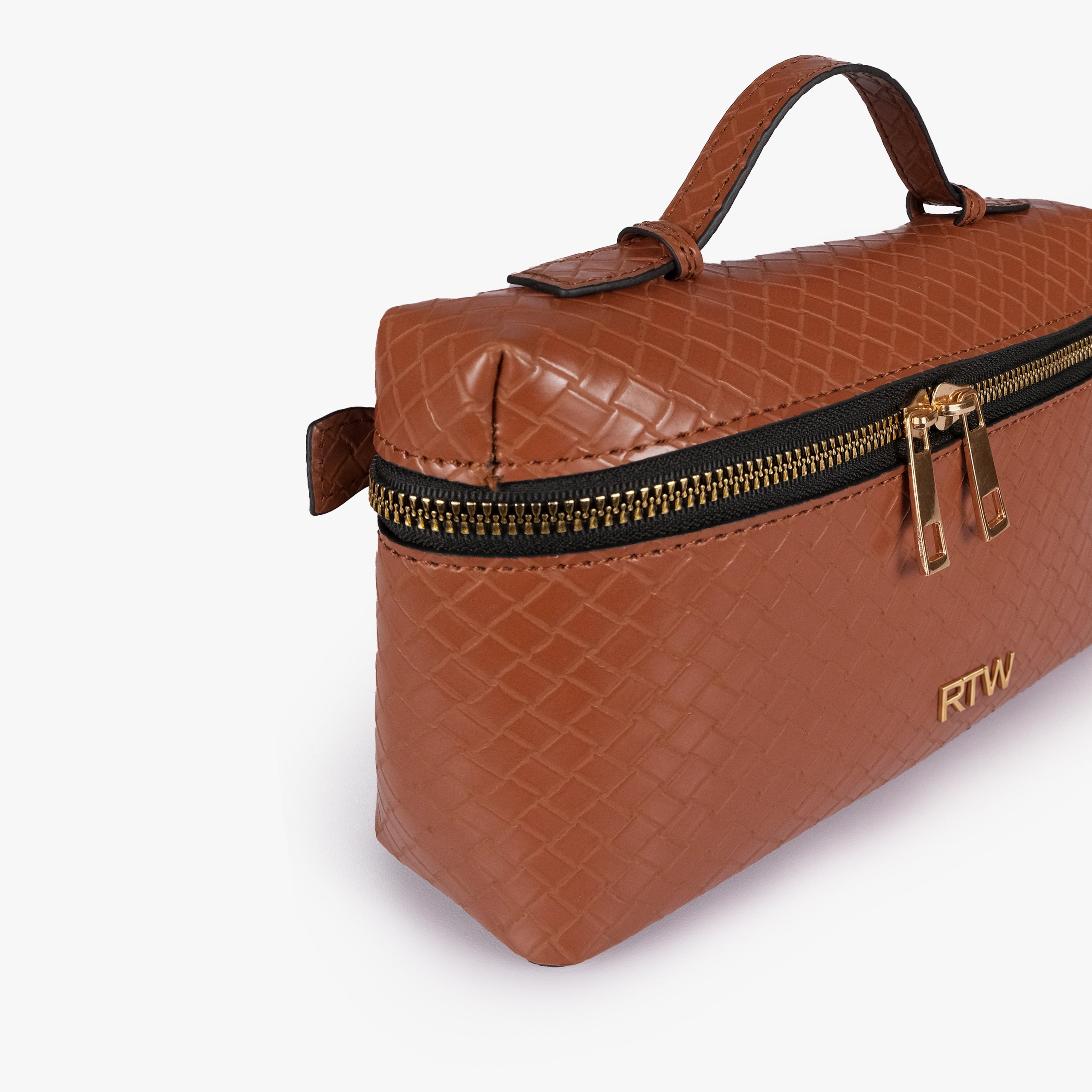 Terracotta weave vanity top-handle bag — closeup of the diamond-quilted faux-leather finish, stitching, dark zipper tape, gold-tone zipper pulls, and small front hardware mark