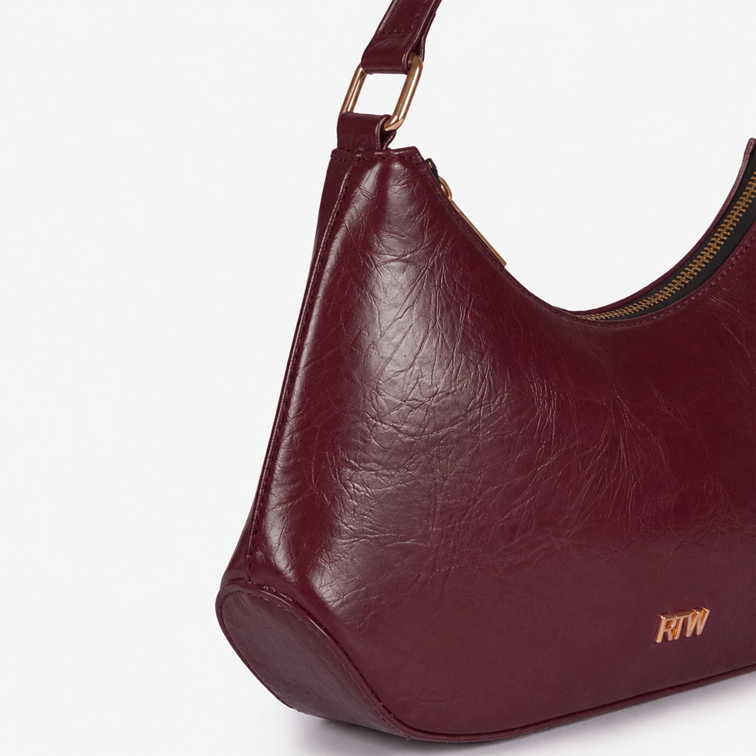 Maroon crinkle shoulder bag — closeup showing the crinkled faux-leather texture and crinkled texture, zip-top detail, and minimal gold-tone detail