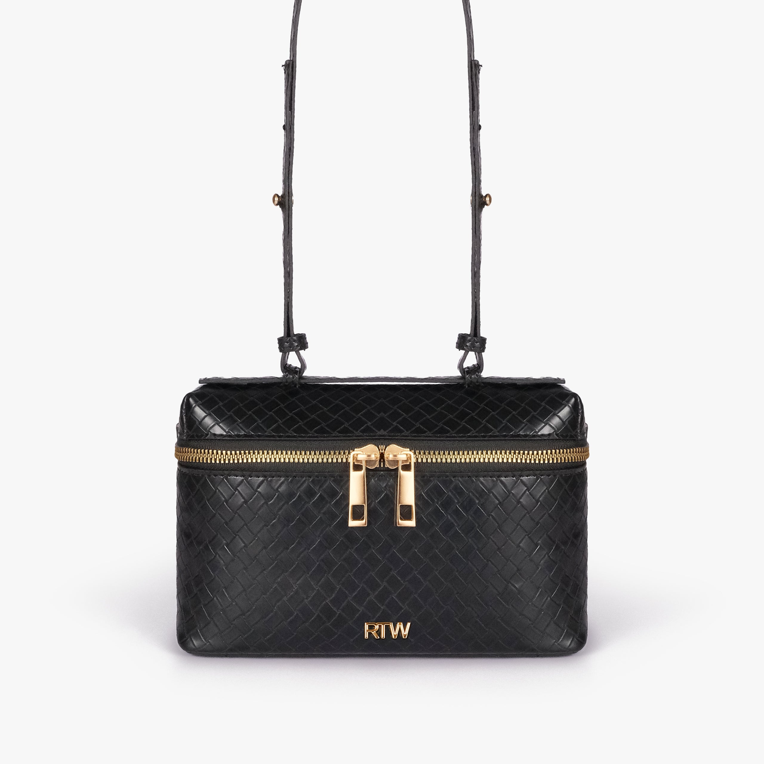 Black weave vanity top-handle bag — front straight-on view showing the diamond-quilted vanity body, short top handle, long strap, wraparound zipper, and small front logo mark