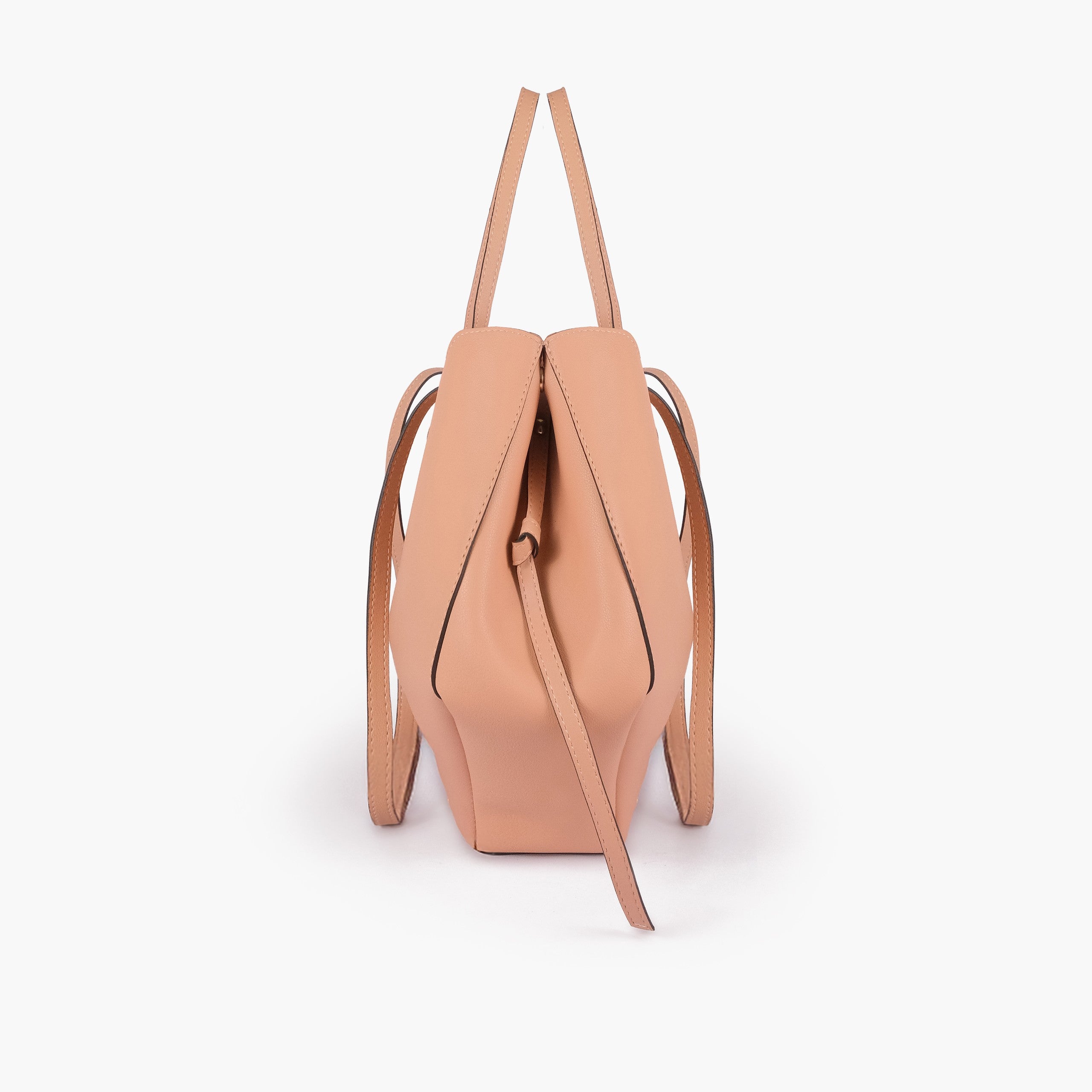 Peach atelier tote — side profile showing wing-cut origami fold, cinch tie, and slim shoulder handle
