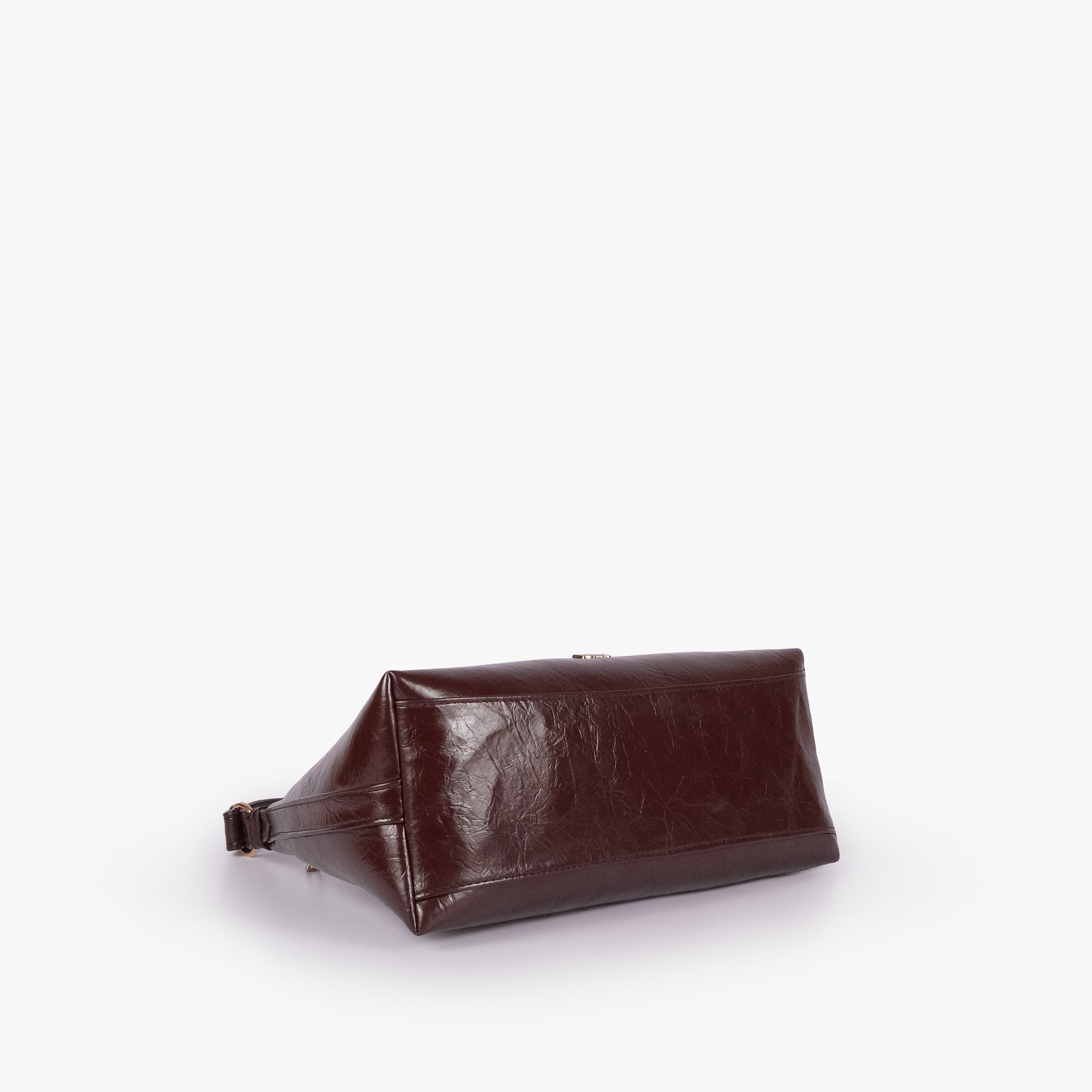 Dark brown crinkle crescent hobo — base view showing the matching faux-leather bottom and softly structured shape