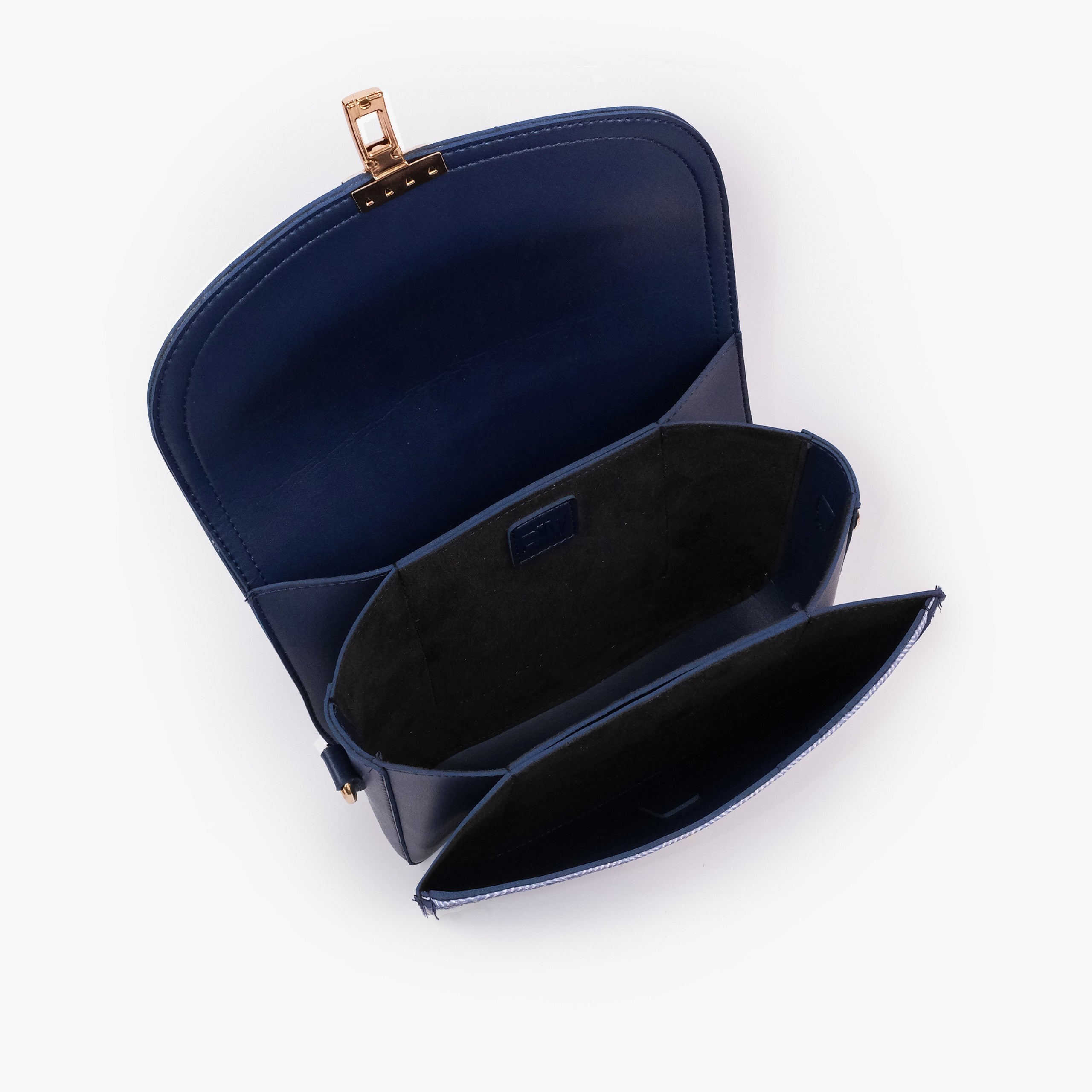 Navy contrast cross-body bag — interior open top-down, deep navy suede-feel lining, two compartments and center divider slip pocket