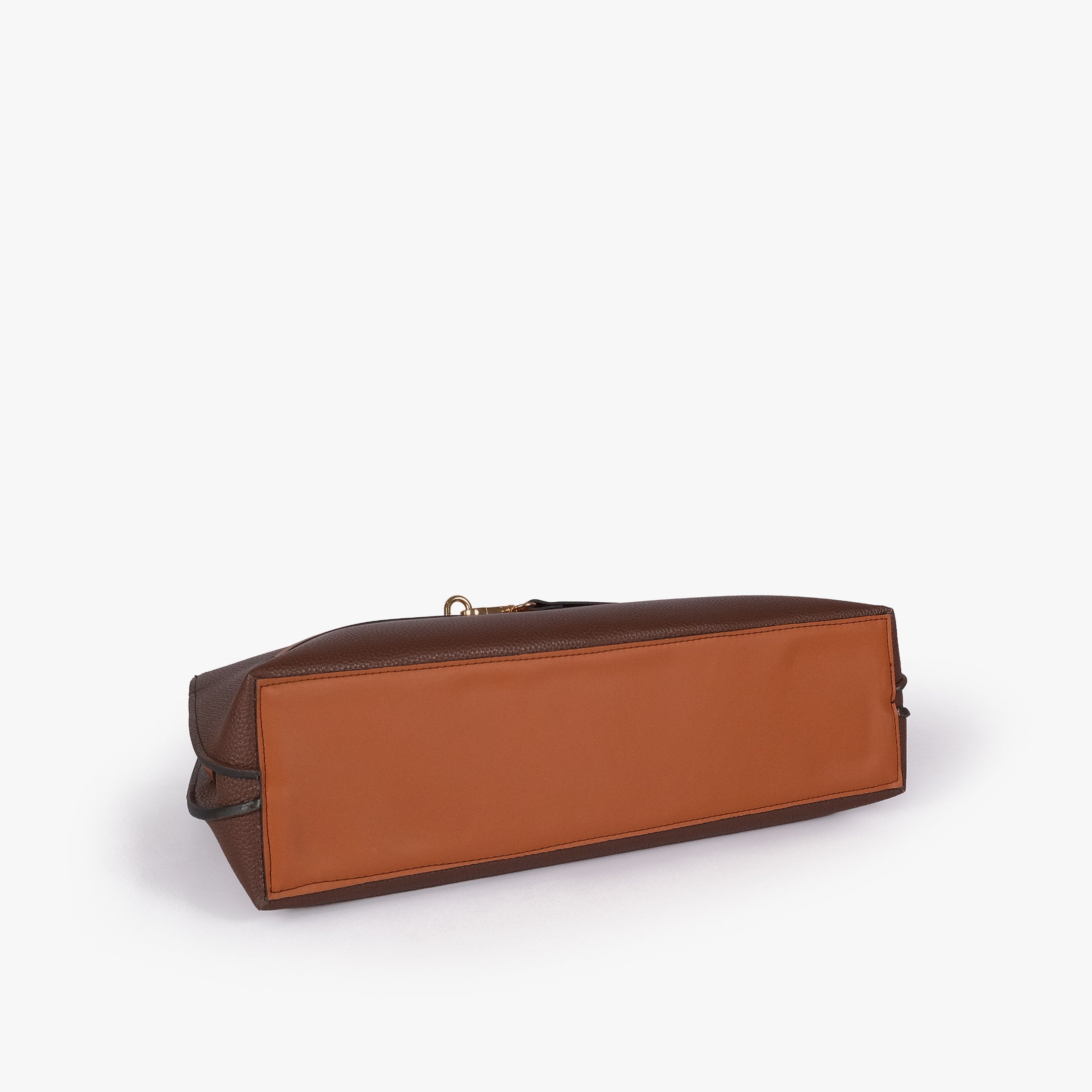 Dark brown Monday Tote — underside tilted view showing reinforced cognac smooth base panel and dark brown pebbled sides