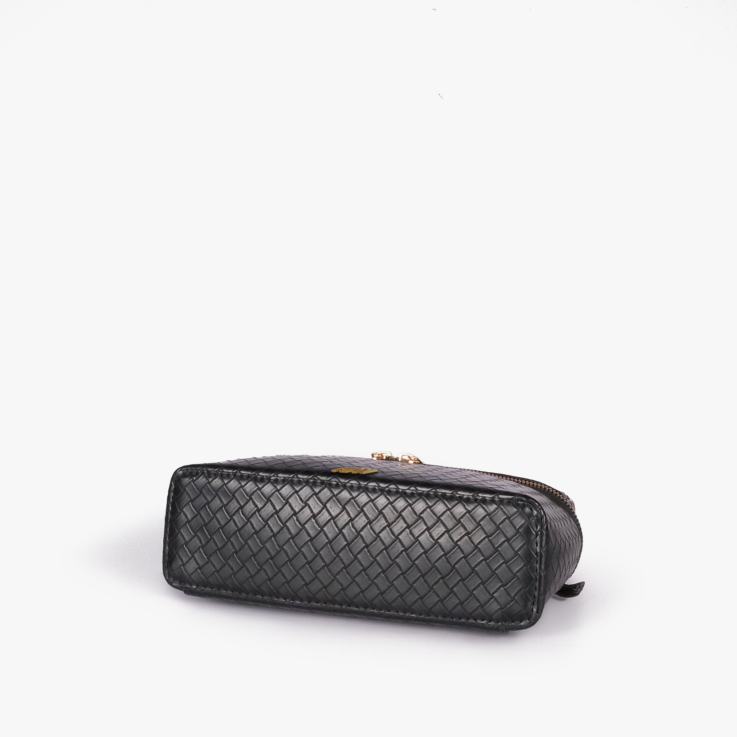 Black weave vanity top-handle bag — base angle showing the elongated flat rectangular bottom with rounded corners and continuous diamond quilting