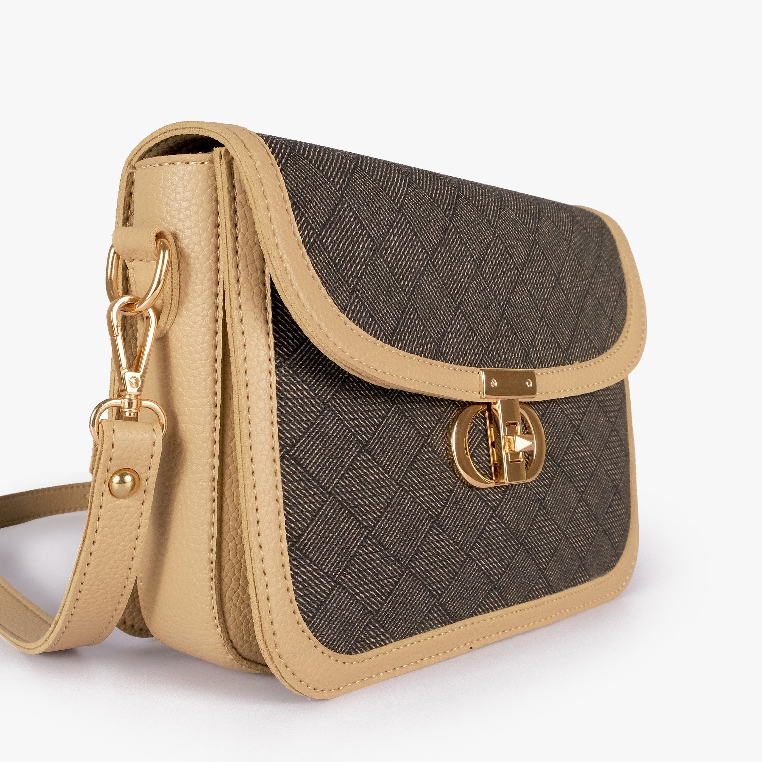 Mocha contrast cross-body bag — closeup of dark charcoal crosshatch box-texture panel, cream pebbled trim border, and gold twist-lock rockstud