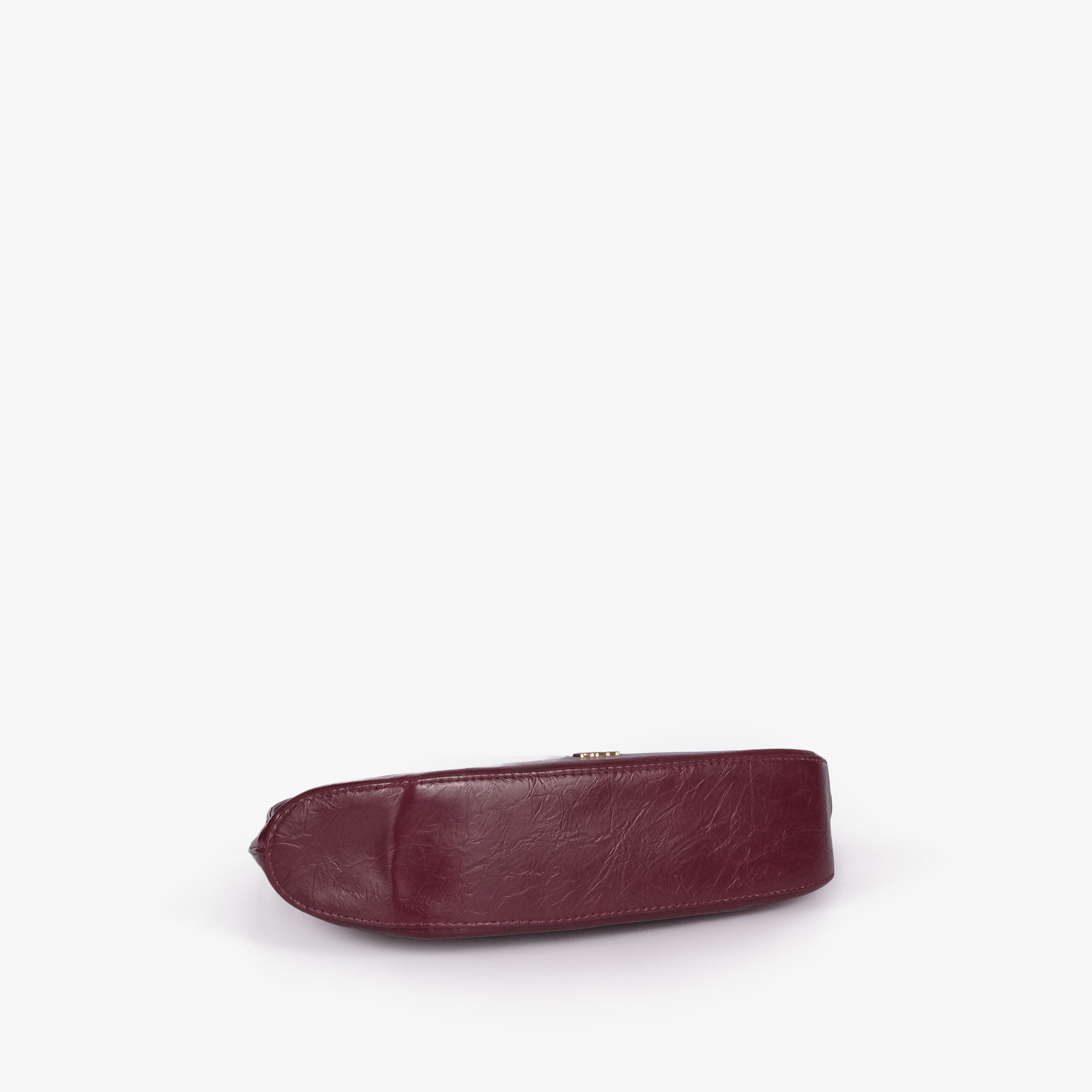 Maroon crinkle shoulder bag — base view showing the matching faux-leather bottom and softly structured shape