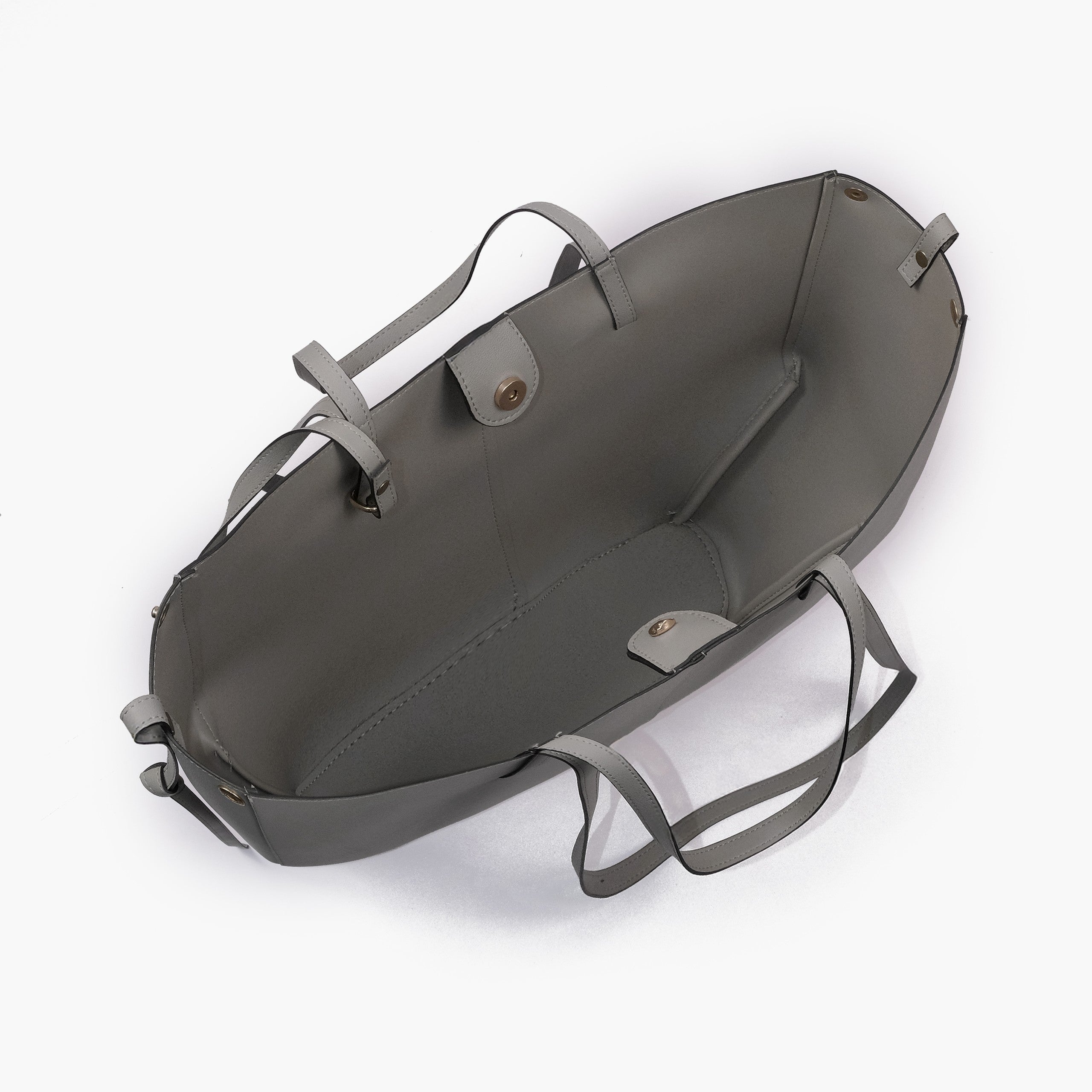 Grey atelier tote — interior top-down view with smooth deeper cool grey faux leather lining, center divider panel, gold magnetic snap