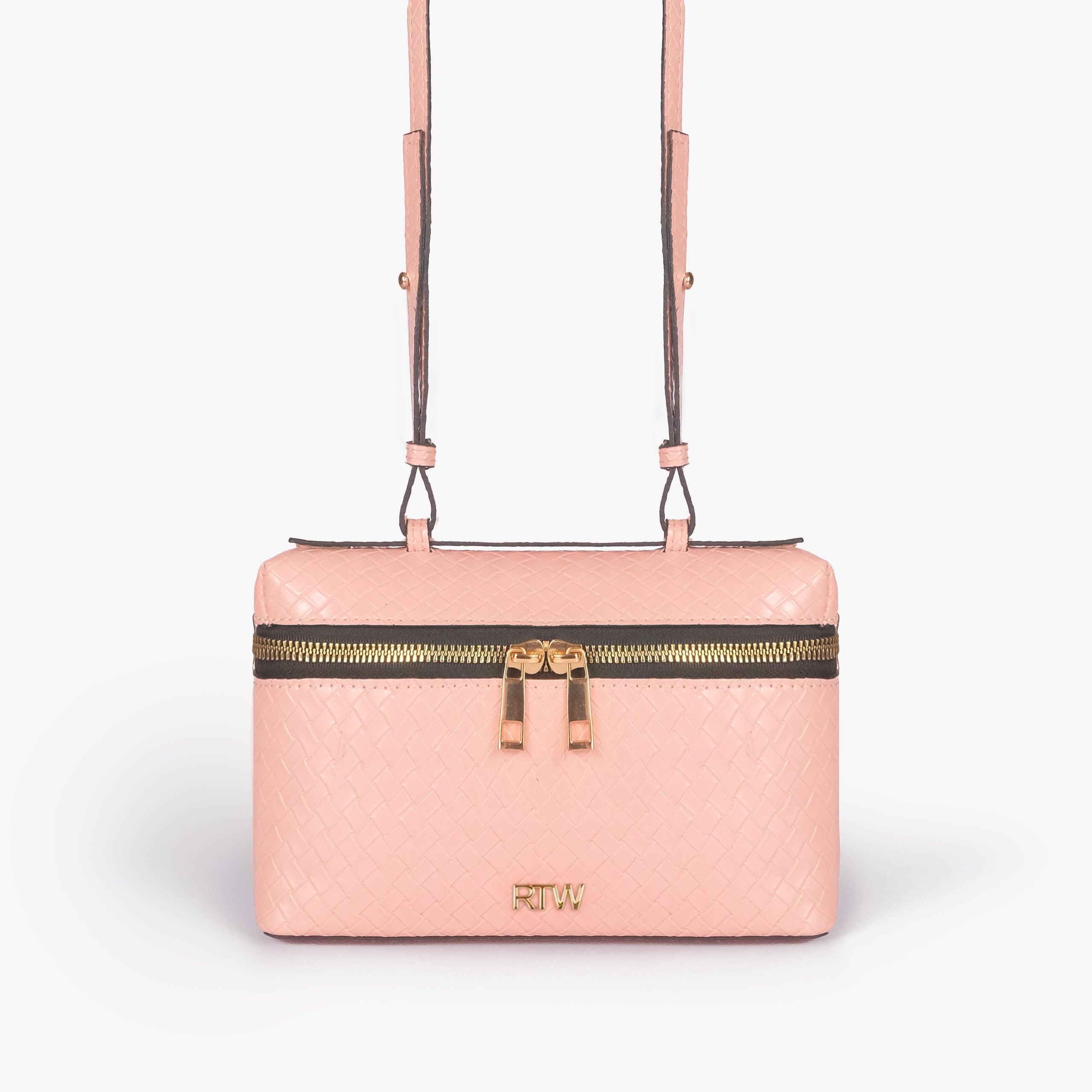 Peach weave vanity top-handle bag — front straight-on view showing the diamond-quilted vanity body, short top handle, long strap, wraparound zipper, and small front logo mark
