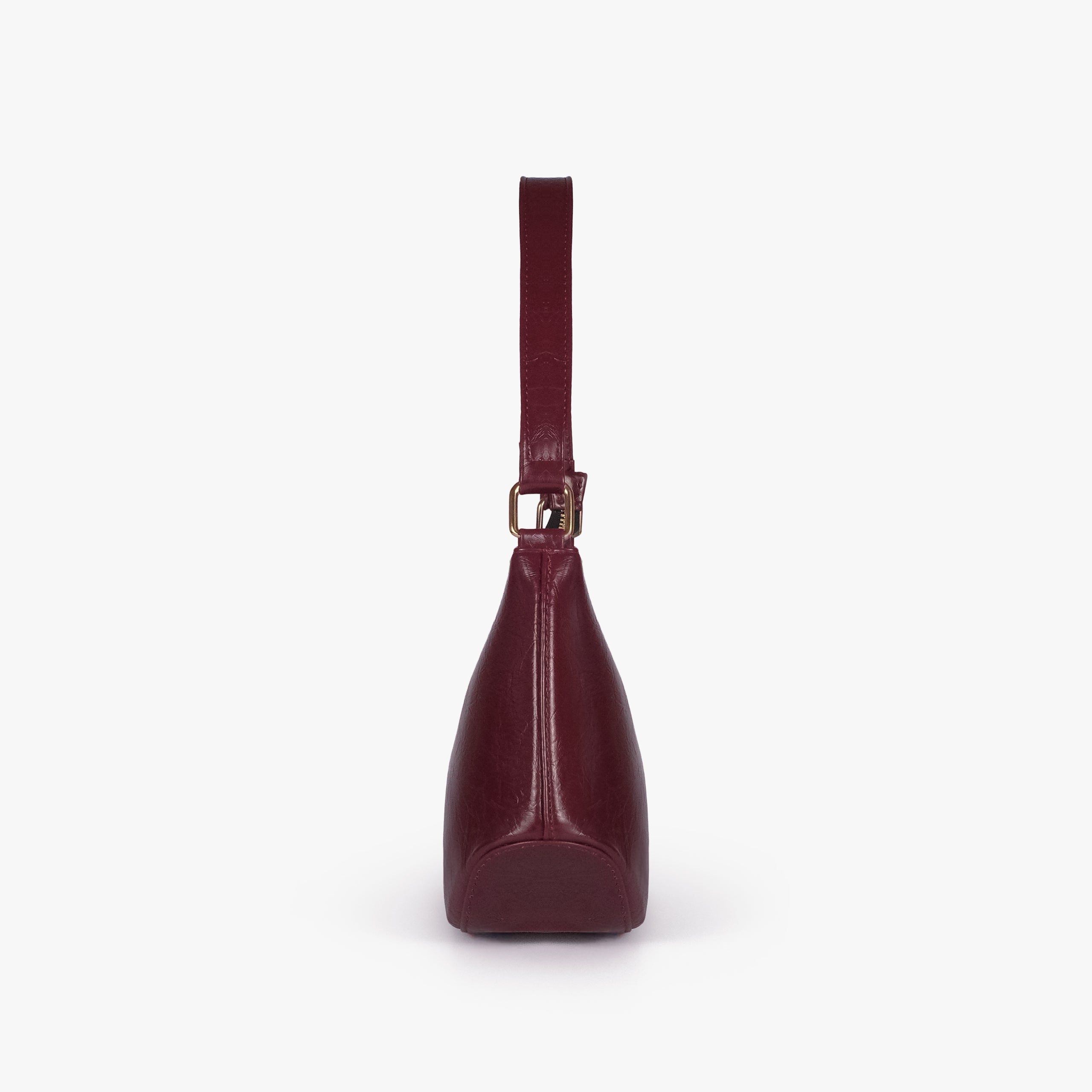Maroon crinkle shoulder bag — side profile showing the tapered depth and arched shoulder handle